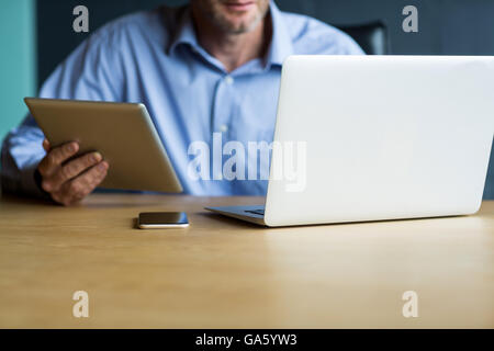 Man using laptop in creative office Stock Photo