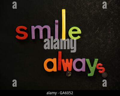 Smile! Inspirational message in vibrant colorful magnet letters Stock Photo