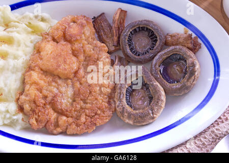 Wiener Schnitzel - breaded meat with potato and mushrooms Stock Photo