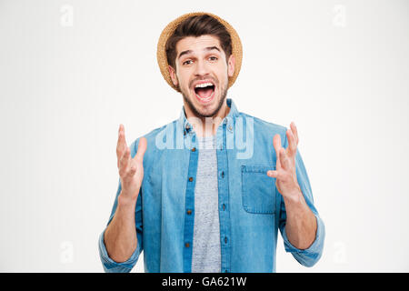 Happy excited young man celebrating success and shouting over white background Stock Photo