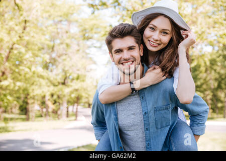 Portrait of a happy young smiling couple having fun outdoors in the park Stock Photo