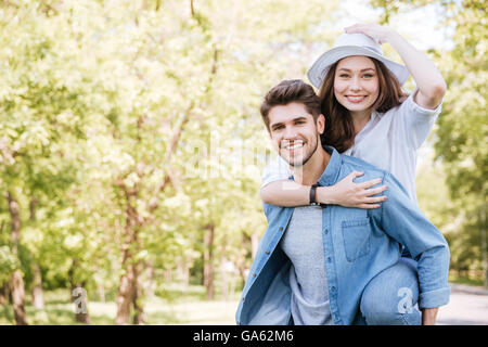 Portrait of a happy young smiling couple having fun outdoors in the park Stock Photo