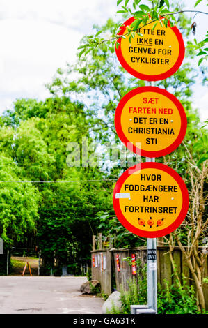 'This is not a shortcut for cyclists. Slow down. Pedestrians have priority on paths in Christiana.' Stock Photo