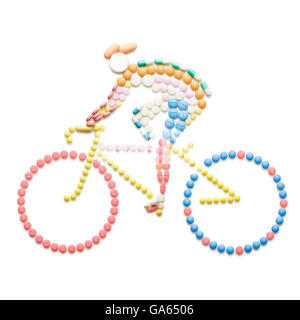 Doping drugs and pills in the shape of a road bicycle racer on a bike. Stock Photo