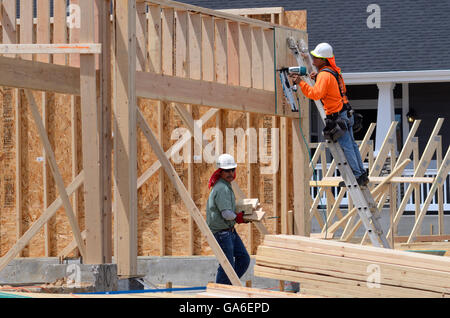 Carpenters work on framing in new subdivision in Superior Colorado Stock Photo
