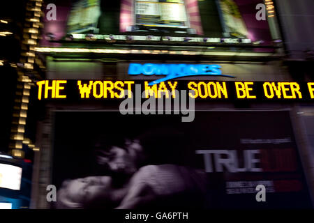Dow Jones electronic news ticker on Times Square in New York 25 June 2009. Message reads 'the worst may soon be over'. Stock Photo