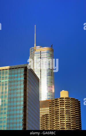 A pair of Chicago building landmarks exist as neighbors with Trump Tower rising above the distinctive twin Marina City Towers. Chicago, Illinois, USA. Stock Photo