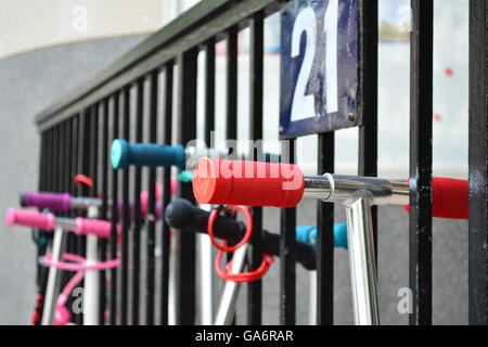 Handlebars of Kids roller scooters parked in the city Stock Photo