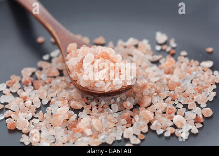 Himalayan pink rock salt in wooden spoon closeup Stock Photo