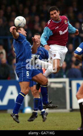 Macclesfield's Darren Tinson is outjumped by West Ham United's Paul Kitson Stock Photo