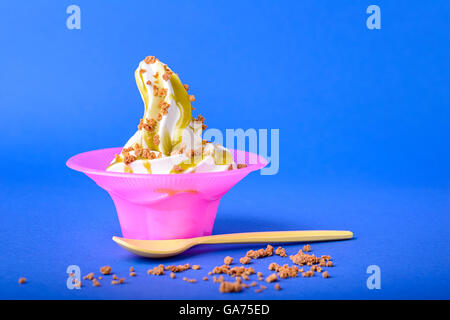 pour the frappe from the shaker into a tall glass , beautiful and clean  composition with coffee beans and amaretti biscuits Stock Photo - Alamy