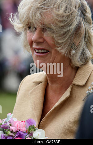 AP AND AFP OUT. The Duchess of Cornwall braves the blustery conditions as she tours the Sandringham Flower Show, on the Sandringham Estate, in Norfolk. Stock Photo