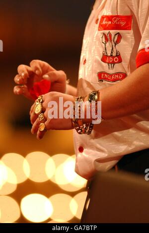 Darts - Embassy World Darts Championships - Final - Frimley Green. Mervyn King has his hands surrounded in gold rings and chains as he adjusts his darts in the Embassy World Darts Championship Final. Stock Photo