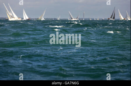 General view of competing yachts beating out of The Solent at the start of the Rolex Fastnet Race near Cowes, Isle of Wight. Stock Photo