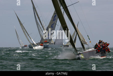 General view of ICAP Leopard and other competing yachts beating out of The Solent at the start of the Rolex Fastnet Race near Cowes, Isle of Wight. Stock Photo