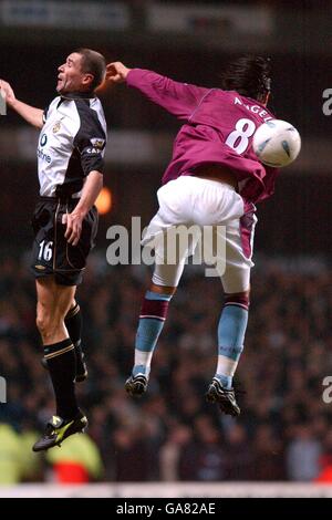 Manchester United's Roy Keane battles for possession of the ball in the air with Aston Villa's Juan Pablo Angel Stock Photo