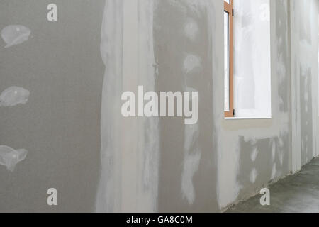Unfinished wall with window in apartment Stock Photo