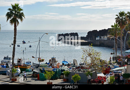 Harbour area with Fishing boats and people in restaurants at Camara de Lobos in Madeira, Portugal Stock Photo