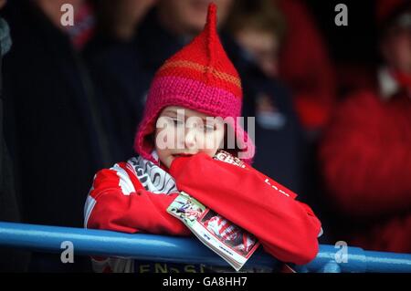 Soccer - AXA FA Cup - Fourth Round - Cheltenham Town v Burnley. A young Cheltenham Town fan watches the game Stock Photo