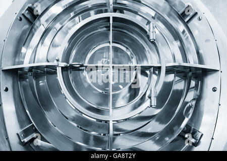 Close up blue toned photo of vintage lighthouse lamp with ring shaped lenses Stock Photo