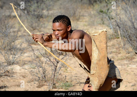 Bushmen hunting with a bow and arrow at the Bushman cultural Stock ...