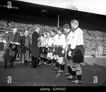 Sir Anthony Eden, British Foreign Minister shakes hands with members of the German team before the match at Wembley. Stock Photo