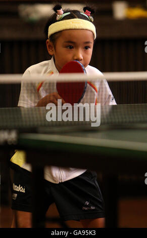 Japanese Table Tennis prodigy Mima Ito, 6, during a game against veteran table tennis champion Edna Fletcher, 81, held at Great Yarmouth Town Hall, Norfolk. Stock Photo