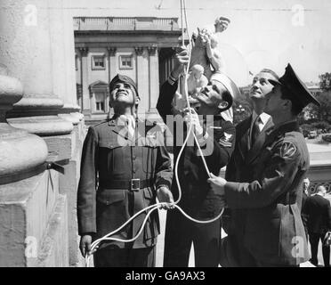 Marine Pvt. Ira Hayes, Pharmacist Mate 2nd Class John H. Bradley, Secretary of the Navy James Forrestal and Marine Private Rene Gagnon (l-r), survivors of the historic flag-raising on Iwo Jima, hoist the same flag over the U.S. Capitol to open the 7th War Loan Drive. . Stock Photo