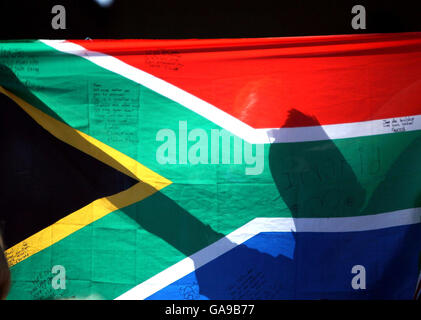 The shadow of a South Africa fan is seen on a flag during the IRB Rugby World Cup Pool A match at Stade Felix Bollaert, Lens, France. Stock Photo