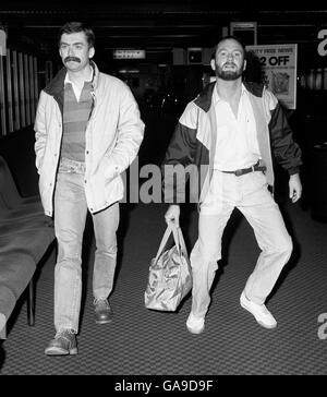 Comedian Kenny Everett (right) at London's Heathrow Airport accompanied by a friend named only as Brian, when he left for a holiday in Madrid. Stock Photo