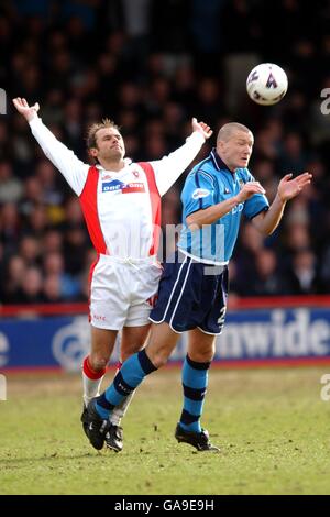 l-r; Rotherham United's Paul Warne battles for possession of the ball in the air with Manchester City's Steve Howey Stock Photo