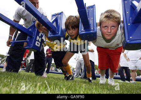 Rugby Union - England O2 Scrum In The Park - Regents Park. Children learn how to scrum during the O2 Scrum In The Park day in Regents Park, London. Stock Photo