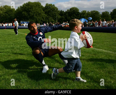 Rugby Union - England O2 Scrum In The Park - Regents Park. England's Jason Robinson is tackled by a young fan during the O2 Scrum In The Park day in Regents Park, London. Stock Photo