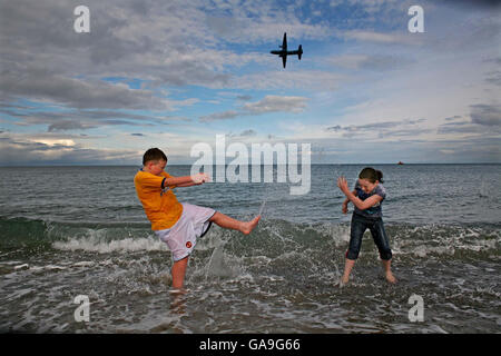 Cillian Donegan, aged 11, and Ciara Mulhern, aged 10, both from Aughrim, Co. Wicklow making a splash at the Bray Air Display, Bray Seafront, Wicklow. The Air Display was a spectacular showcase of the cream of Irish aerobatics. Stock Photo