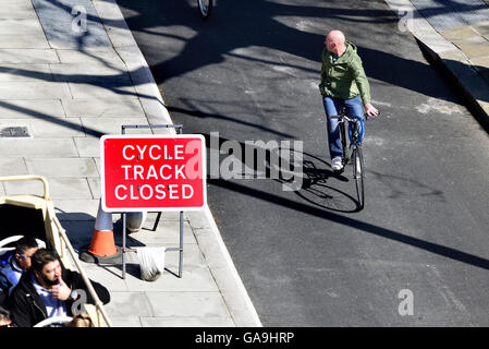 London, England, UK. Cycle Track Closed sign on the Victoria Embankment. People cycling past Stock Photo