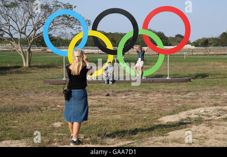 People take pictures of the Olympic rings in the Olympic Equestrian Centre in Deodoro, Rio de Janeiro, Brazil, 04 August 2016. Rio 2016 Olympic Games take place from 05 to 21 August. Photo: Friso Gentsch/dpa Stock Photo