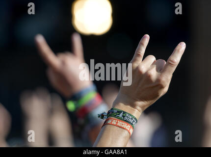 Wacken, Germany. 5th Aug, 2016. Metal fans showing the Metal sign on the festival grounds of Wacken Open Air in Wacken, Germany, 5 August 2016. 75,000 fans are attending what organisers say is the largest heavy metal festival in the world. PHOTO: AXEL HEIMKEN/dpa/Alamy Live News Stock Photo