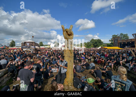 Wacken, Germany. 5th Aug, 2016. Metal fans waiting for the start of a concert on the festival grounds of Wacken Open Air in Wacken, Germany, 5 August 2016. 75,000 fans are attending what organisers say is the largest heavy metal festival in the world. PHOTO: AXEL HEIMKEN/dpa/Alamy Live News Stock Photo