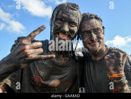 Wacken, Germany. 5th Aug, 2016. Metal fans celebrating on the festival grounds of Wacken Open Air in Wacken, Germany, 5 August 2016. 75,000 fans are attending what organisers say is the largest heavy metal festival in the world. PHOTO: AXEL HEIMKEN/dpa/Alamy Live News Stock Photo