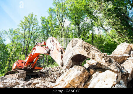 Excavator with big shovel to work with rocks Stock Photo