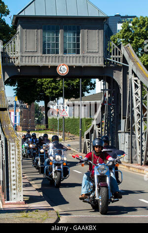 Germany, Cologne, biker on the pivot bridge at the harbor in the district Deutz. Stock Photo