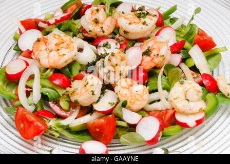 Salad with shrimps, field salad, radish, pepper and onions Stock Photo