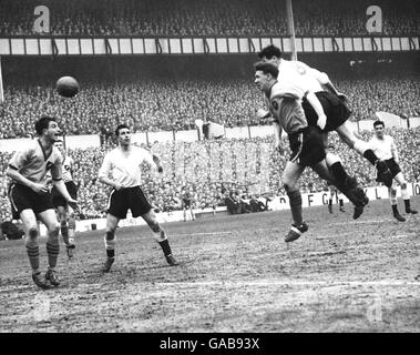 Luton Town's Allan Brown heads over Tottenham Hotspur goalkeeper John ...