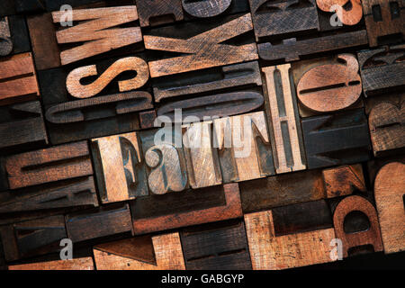 faith word made from wooden letterpress blocks inside many letters background Stock Photo