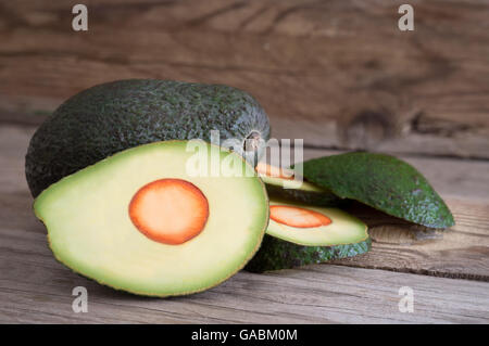 fresh avocado sliced on wooden table Stock Photo