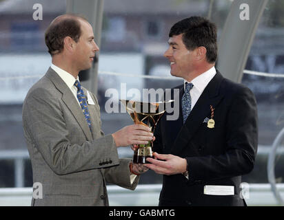 HRH The Earl of Wessex presents the winning owner trophy to Simon Crisford (Godolphin Racing Manager) after Ramonti wins The Queen Elizabeth II Stakes during The Mile Championships day at Ascot Racecourse. Stock Photo