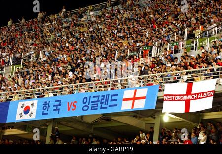 International Soccer - Friendly - South Korea v England. West Bromwich Albion fans put their flag next to a Korean banner in the Jeju World Cup Stadium Stock Photo