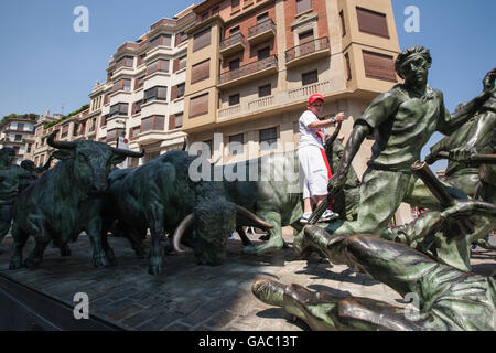 Running of bulls through streets of Pamplona,Spain.Statue  on  Avenida Roncesvalles  by  Rafael  Huerta  1991  depicting  the  ' Stock Photo
