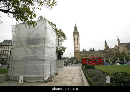 A statue of David Lloyd George stands hidden behind sheets of tarpaulin in Parliament Square, Westminster, central London. Stock Photo