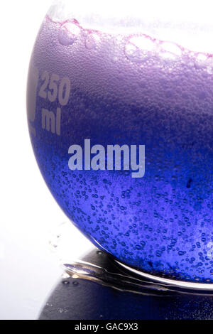 blue chemical reaction in boiling flask Stock Photo